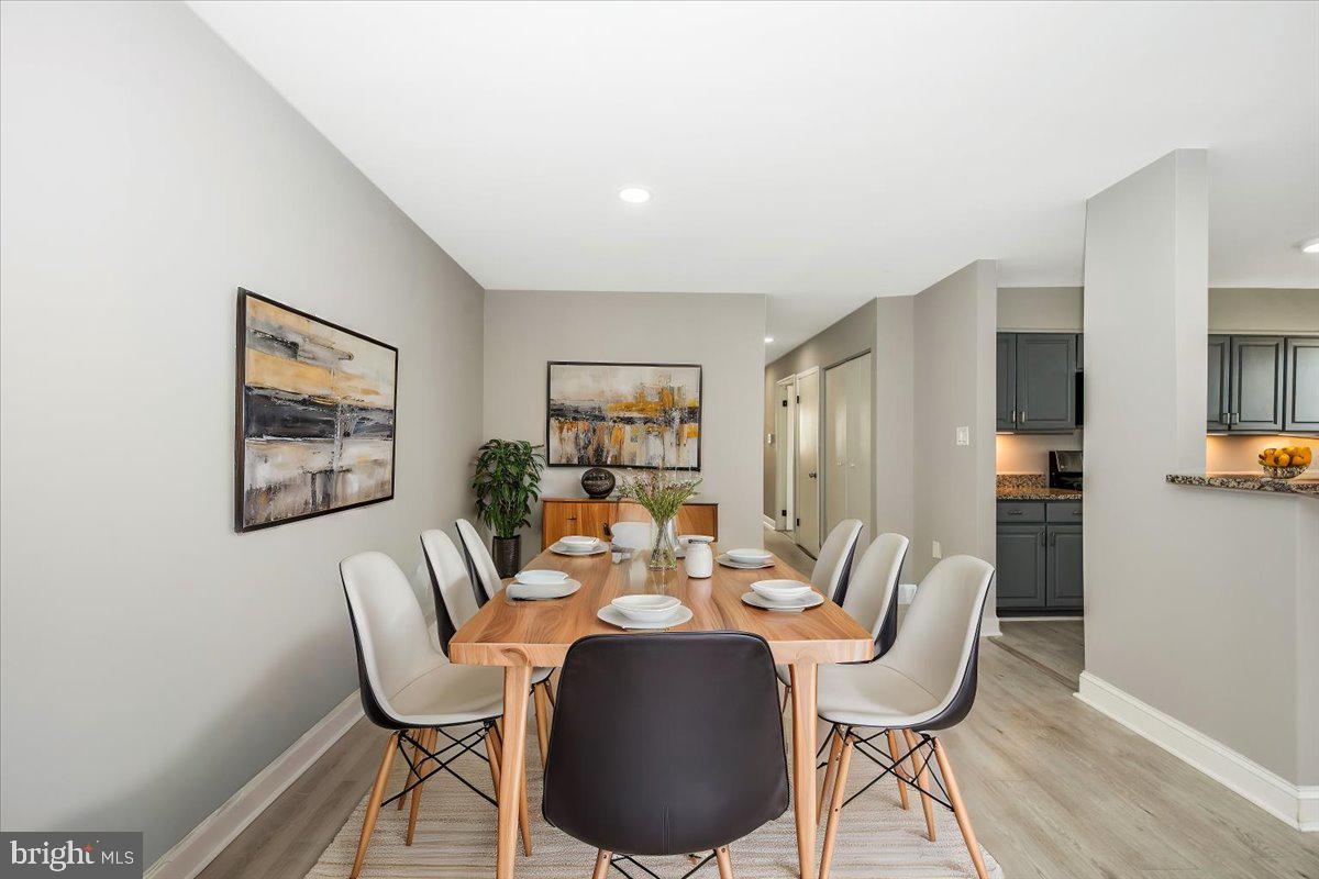 11368 Cherry Hill Road, Unit 1Q204 Beltsville, MD 20705 - Photo 5 of 46 a dining room with furniture and wooden floor