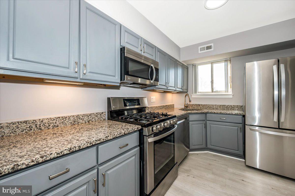 11368 Cherry Hill Road, Unit 1Q204 Beltsville, MD 20705 - Photo 7 of 46 a kitchen with granite countertop stainless steel appliances and cabinets