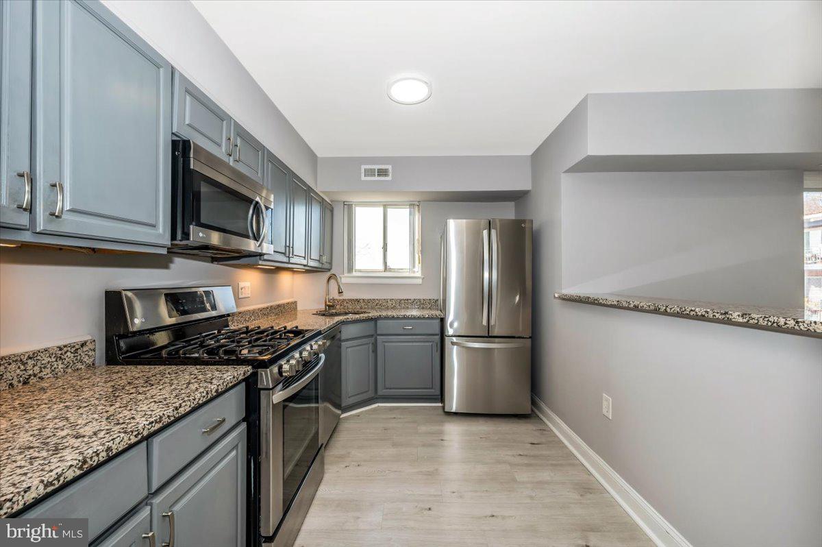 11368 Cherry Hill Road, Unit 1Q204 Beltsville, MD 20705 - Photo 10 of 46 a kitchen with stainless steel appliances granite countertop a sink stove and refrigerator