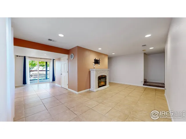 a balcony with wooden floor and outdoor seating