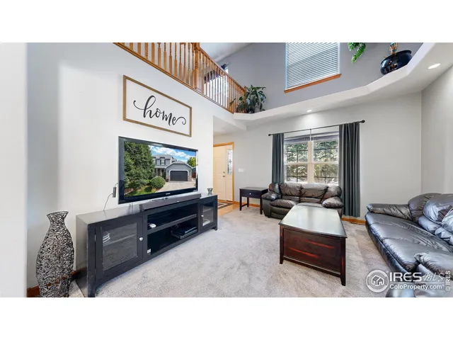 a view of a kitchen with kitchen island a large window cabinets a sink and stainless steel appliances