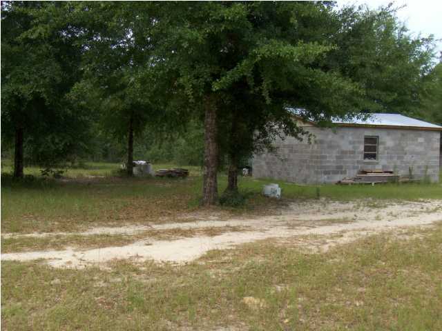 3537 Richardson Road Crestview, FL 32539 - Photo 17 of 29 a backyard of a house with lots of green space