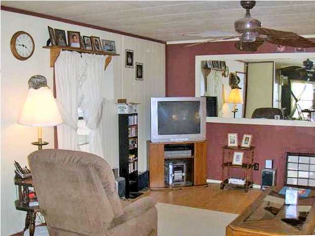 3537 Richardson Road Crestview, FL 32539 - Photo 3 of 29 a living room with furniture a fireplace and a chandelier