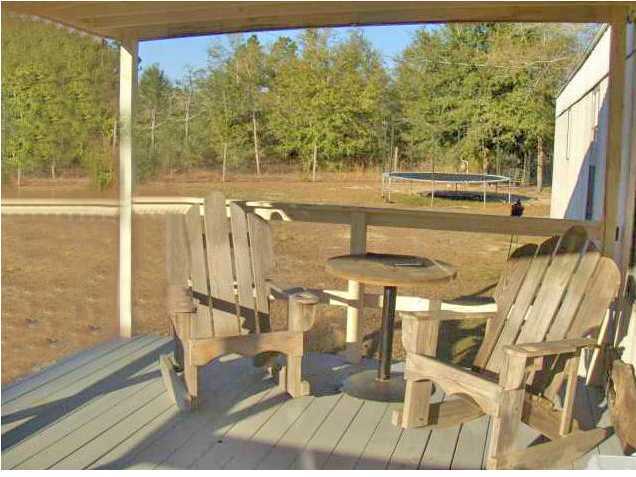 3537 Richardson Road Crestview, FL 32539 - Photo 7 of 29 a view of a living room with a floor to ceiling window and an outdoor view