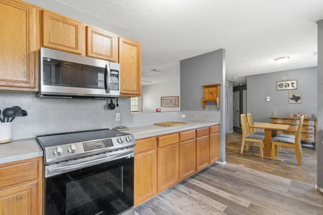 a kitchen with stainless steel appliances a stove microwave and cabinets