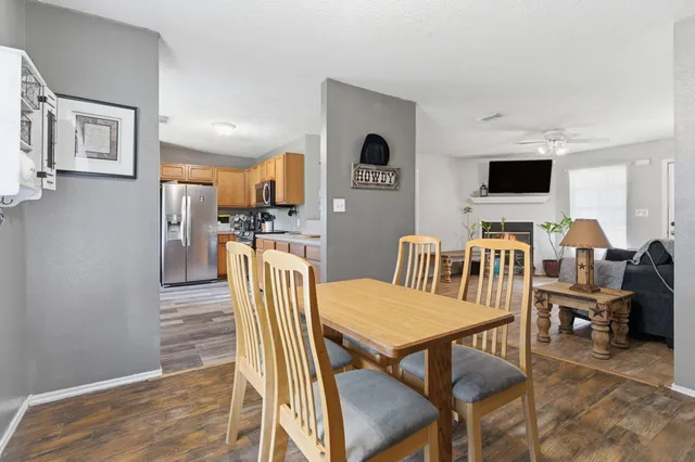 a dining room with furniture and wooden floor