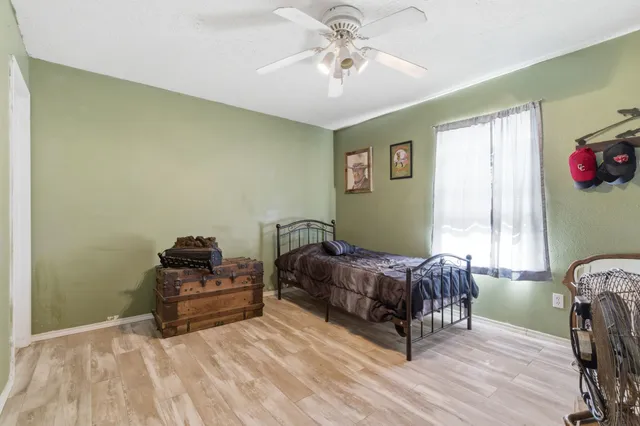 a bedroom with a bed dresser and a window