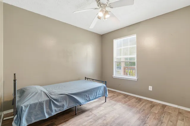 a bedroom with a bed and window