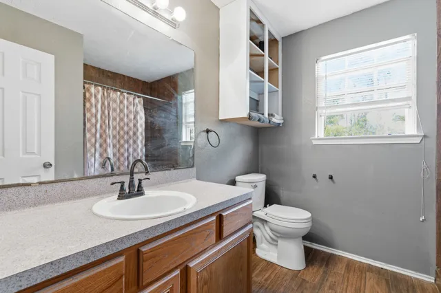 a bathroom with a sink toilet and a mirror
