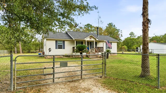 a front view of a house with swimming pool having outdoor seating