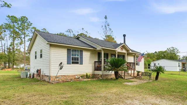 a front view of a house with a garden and yard