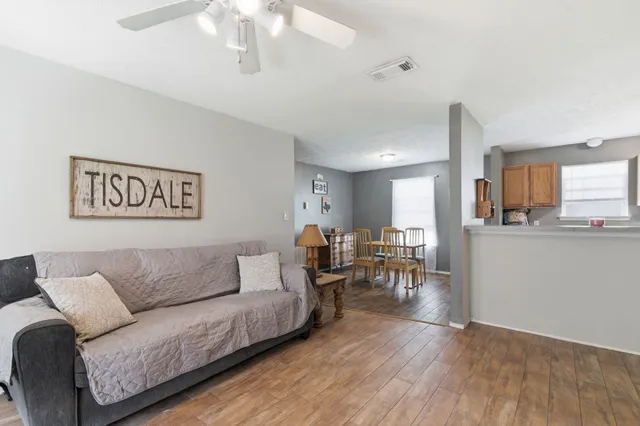 a living room with furniture and kitchen view