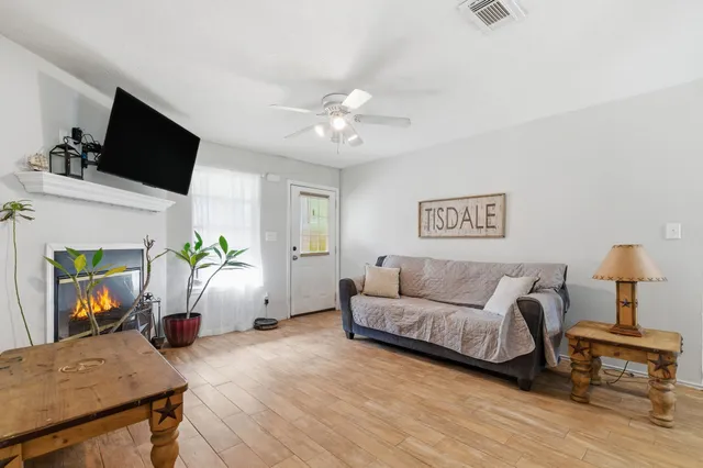 a living room with furniture and a flat screen tv