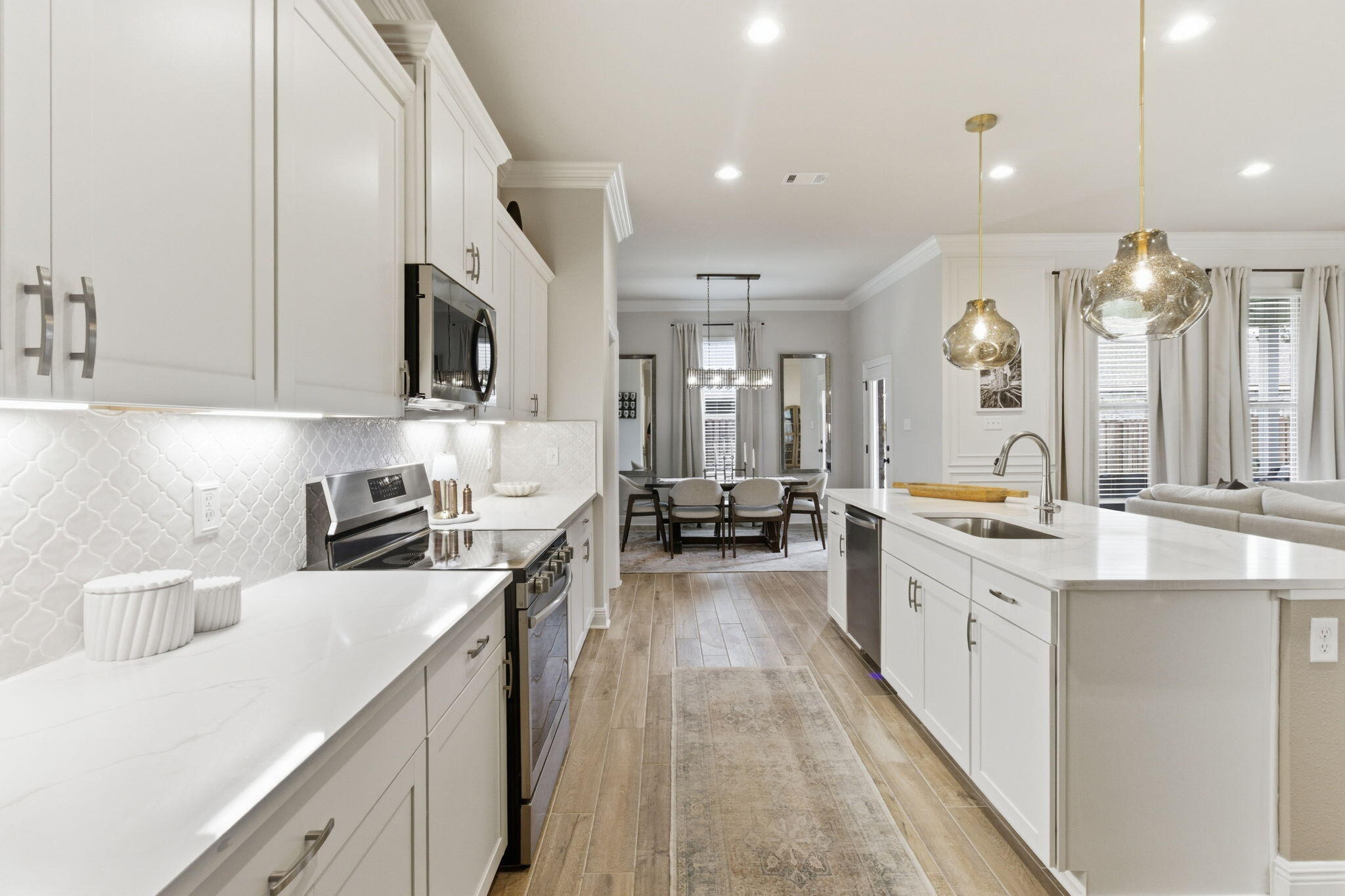 140 Flora Lane Freeport, FL 32439 - Photo 14 of 77 a large white kitchen with stainless steel appliances granite countertop lots of counter top space