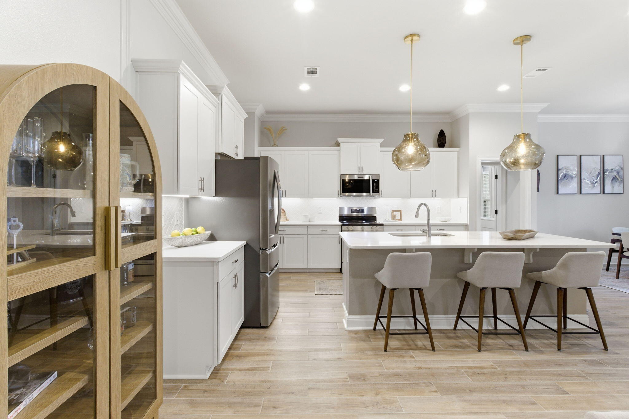 140 Flora Lane Freeport, FL 32439 - Photo 16 of 77 a kitchen with stainless steel appliances a dining table chairs refrigerator and sink