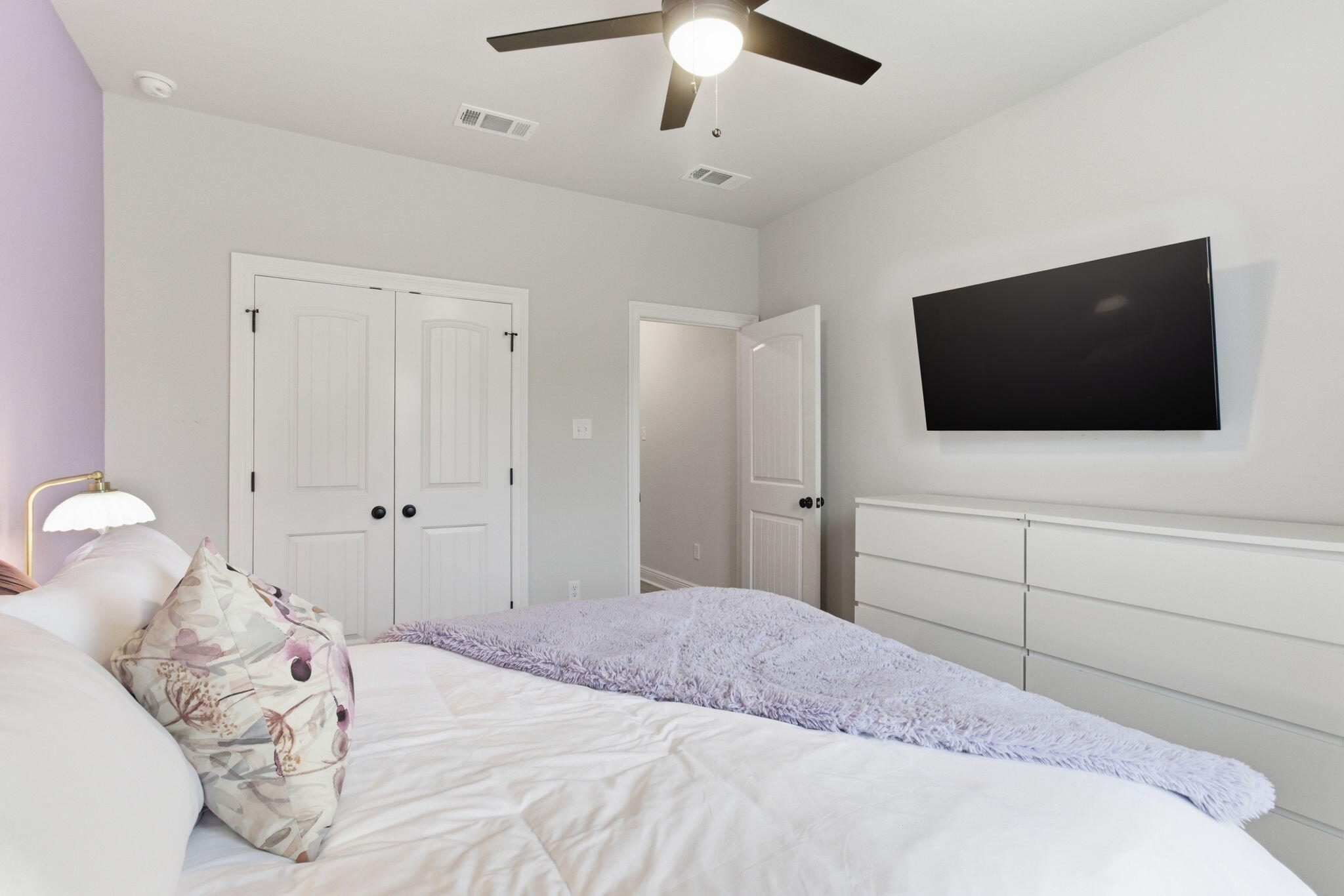 140 Flora Lane Freeport, FL 32439 - Photo 25 of 77 a bedroom with a bed and a flat screen tv in it