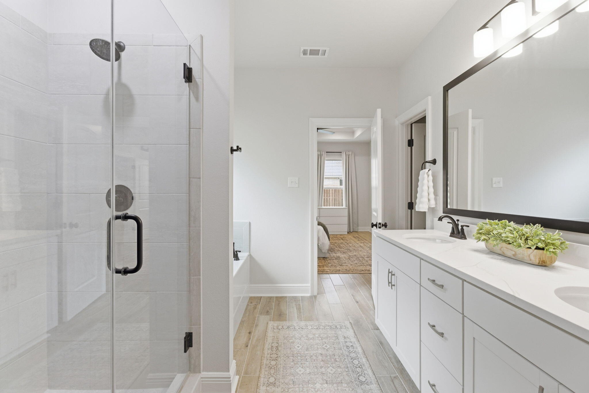 140 Flora Lane Freeport, FL 32439 - Photo 31 of 77 a spacious bathroom with a double vanity sink a shower and a mirror