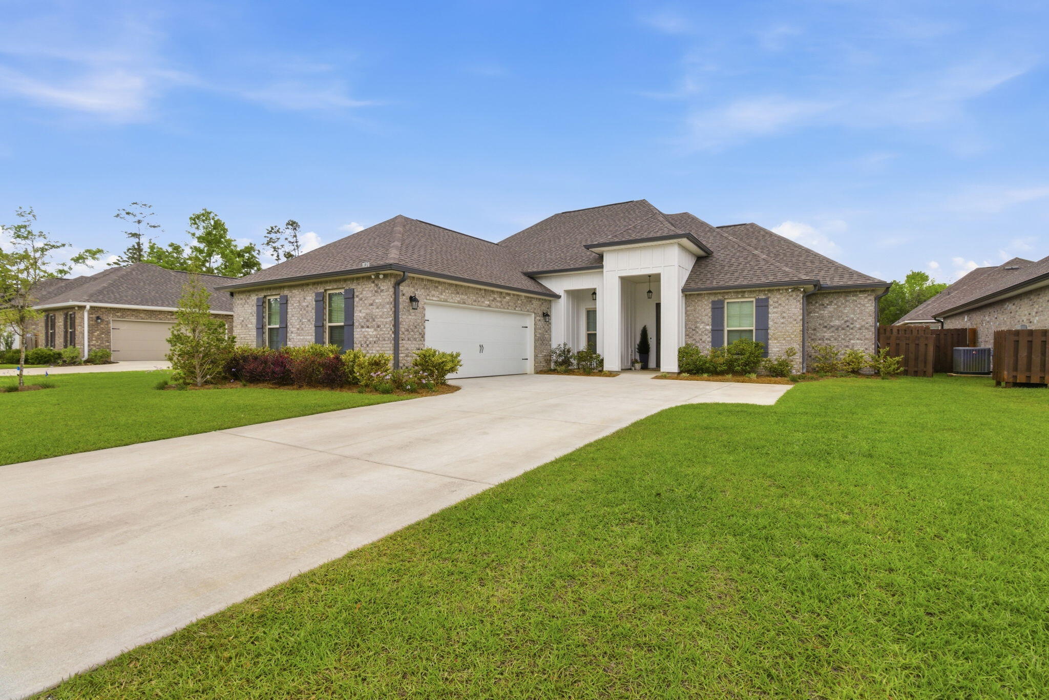 140 Flora Lane Freeport, FL 32439 - Photo 4 of 77 a front view of a house with a garden