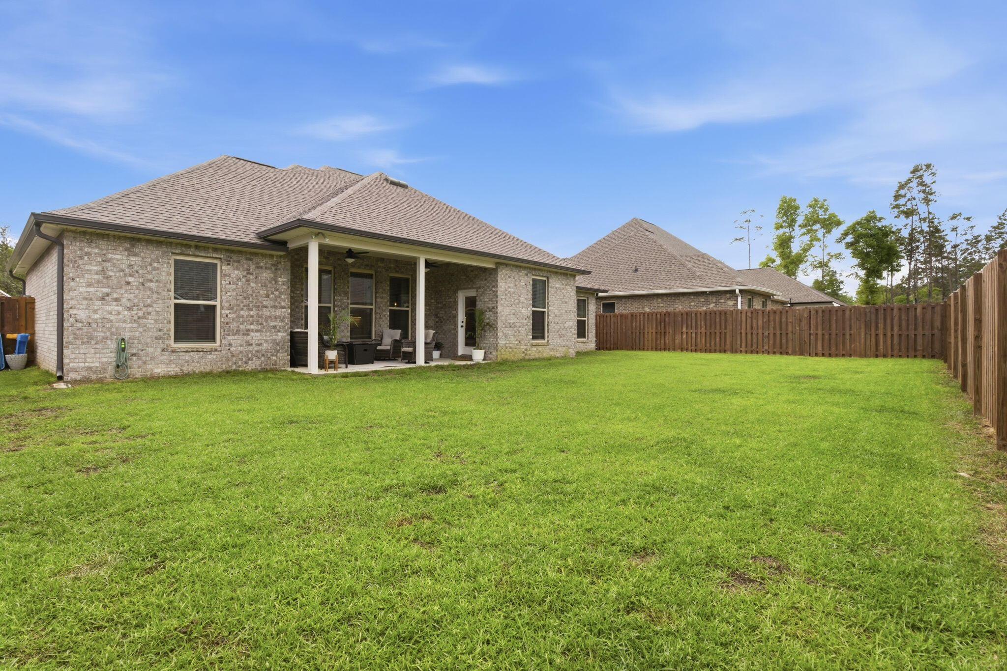 140 Flora Lane Freeport, FL 32439 - Photo 44 of 77 a front view of a house with a garden and yard