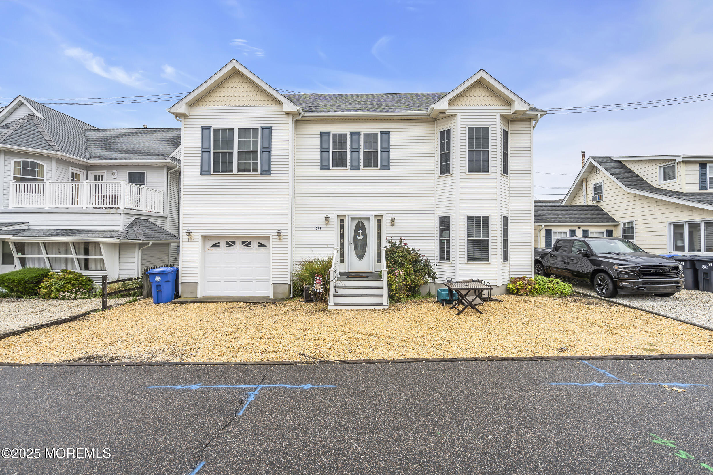 30 South Surf Road Lavallette, NJ 08735 - Photo 5 of 19 a view of a white house with large windows next to a road