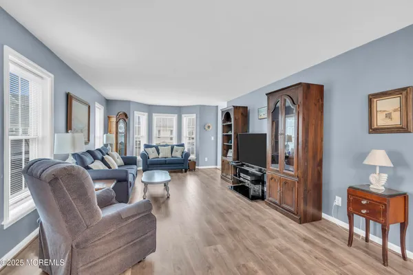 a view of a dining room with furniture window and wooden floor