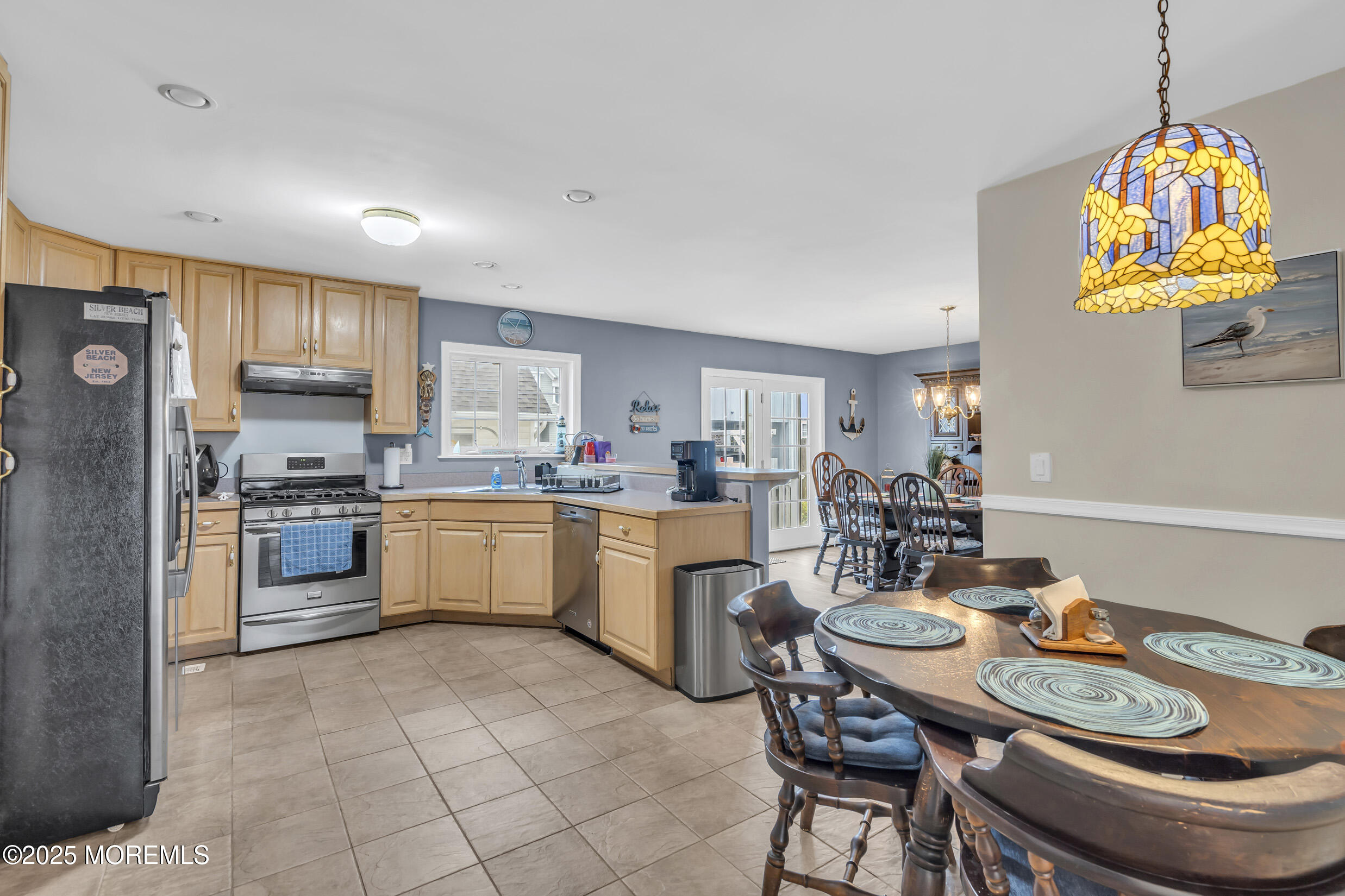 30 South Surf Road Lavallette, NJ 08735 - Photo 8 of 19 a kitchen with stainless steel appliances granite countertop a stove a sink a refrigerator a kitchen island with a dining table and chairs