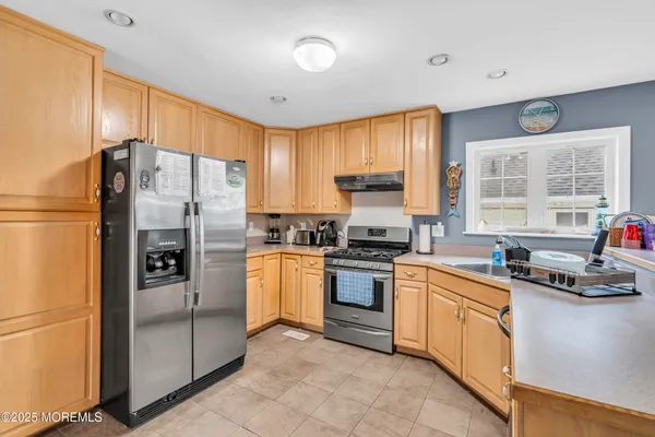 a spacious bedroom with a bed and a chandelier