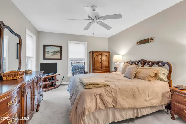 a spacious bedroom with a bed and a chandelier