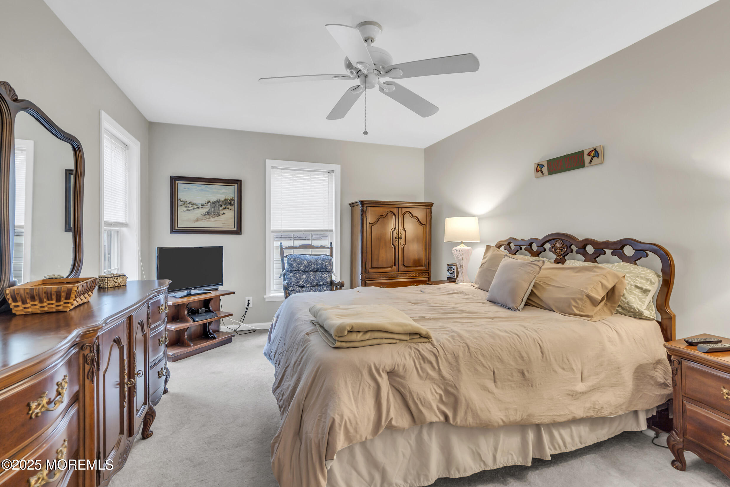 30 South Surf Road Lavallette, NJ 08735 - Photo 10 of 19 a spacious bedroom with a bed and a chandelier