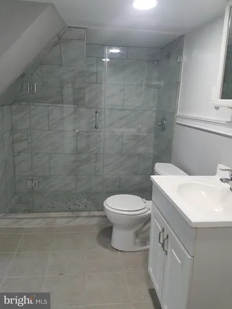 a bathroom with a sink a toilet and mirror