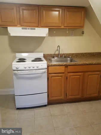 a white toilet sitting next to a bath tub