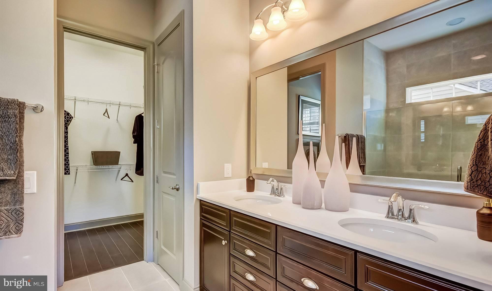 19150 Chartres Street Lewes, DE 19958 - Photo 11 of 12 a bathroom with a double vanity sink mirror and shower