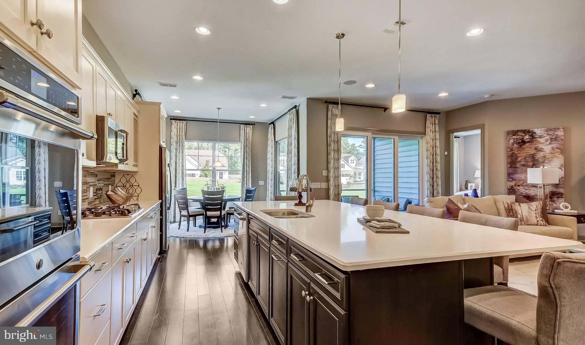 19150 Chartres Street Lewes, DE 19958 - Photo 6 of 12 a kitchen with kitchen island a sink dining table and chairs