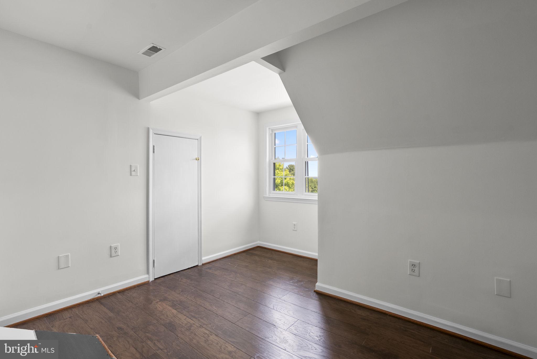24000 Clarksburg Road Clarksburg, MD 20871 - Photo 34 of 60 an empty room with wooden floor and windows