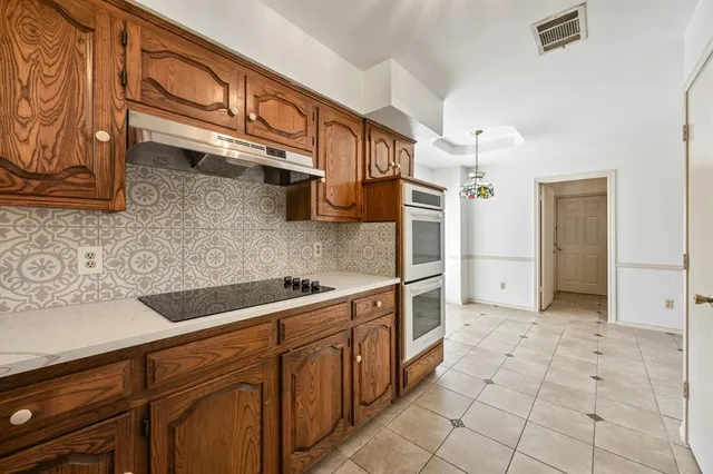 a kitchen with stainless steel appliances granite countertop a sink and cabinets