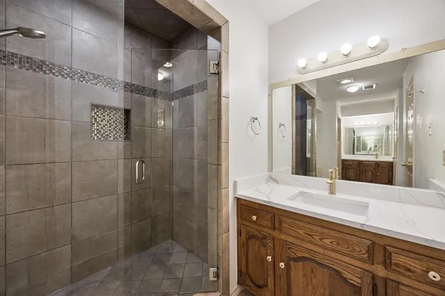 a bathroom with a shower sink and mirror