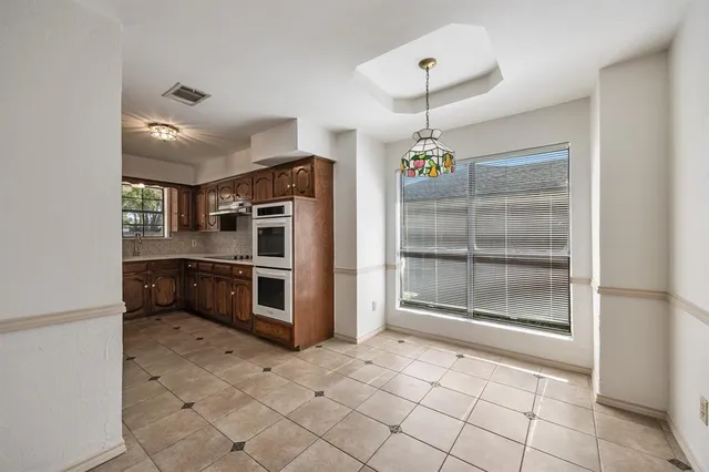 a kitchen with stainless steel appliances granite countertop a stove and a refrigerator