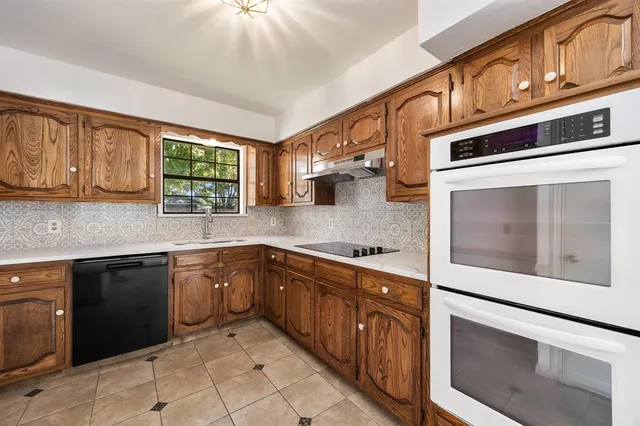 a kitchen with stainless steel appliances granite countertop a stove and a microwave