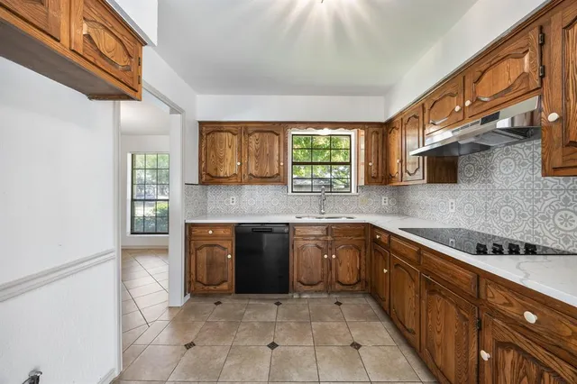 a kitchen with stainless steel appliances granite countertop a sink and cabinets