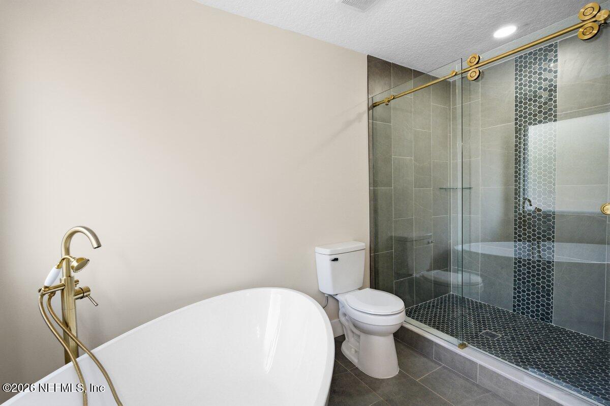 6093 Taylor Road Jacksonville, FL 32234 - Photo 23 of 44 a bathroom with a toilet and a shower