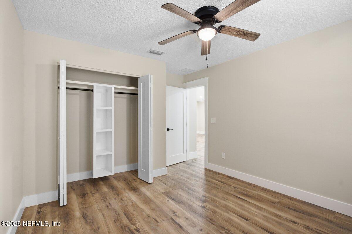 6093 Taylor Road Jacksonville, FL 32234 - Photo 26 of 44 a view of an empty room with wooden floor