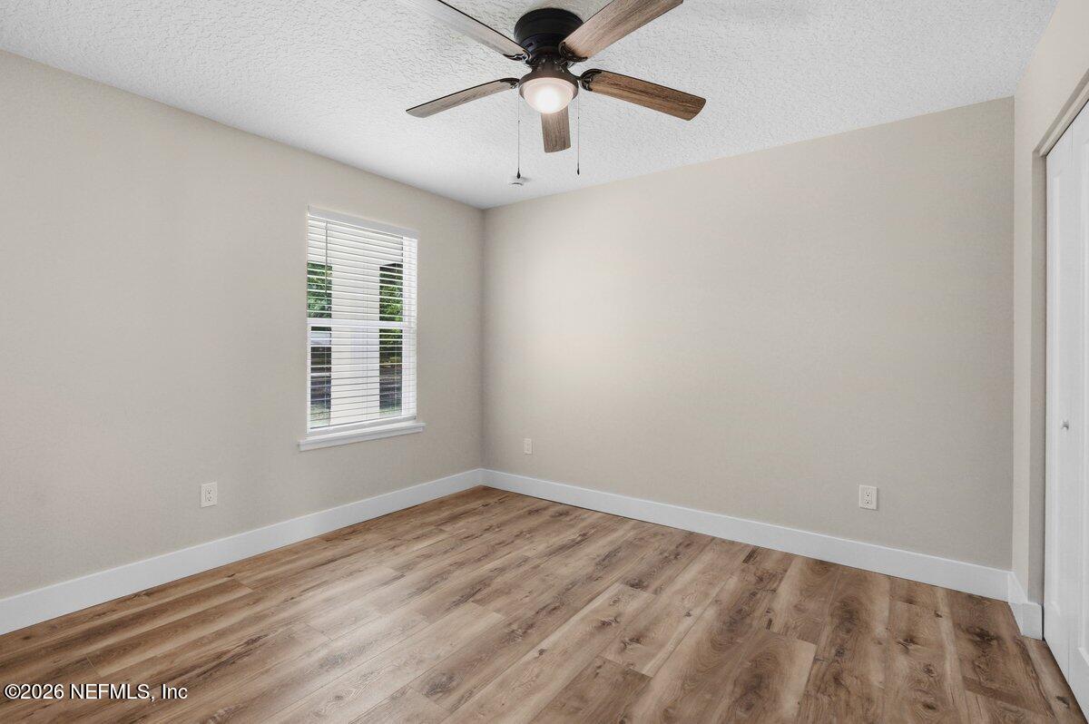 6093 Taylor Road Jacksonville, FL 32234 - Photo 28 of 44 wooden floor in an empty room with a window