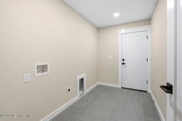 a view of empty room with wooden ceiling