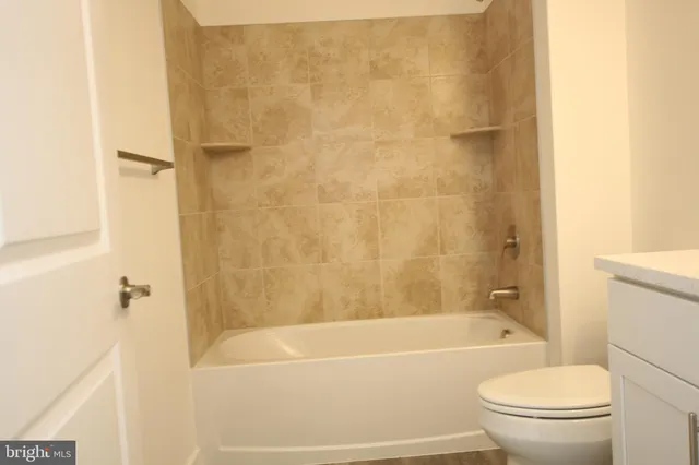 a white bath tub sitting next to a white toilet