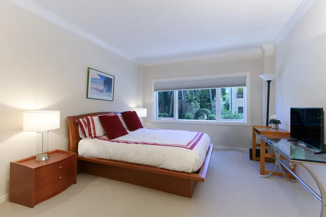 a bathroom with a granite countertop sink a toilet and a shower