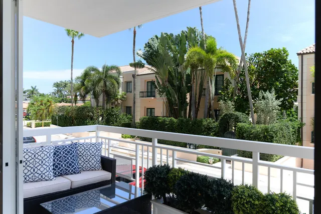 a living room with furniture and a dining table with window