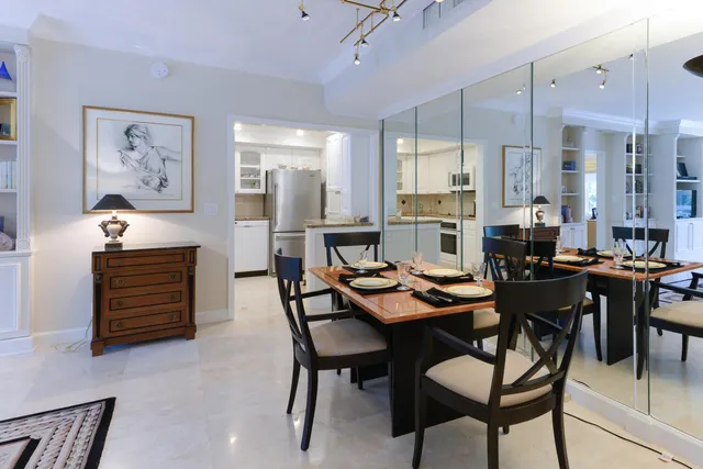 a kitchen with stainless steel appliances kitchen island granite countertop a stove a sink and a microwave