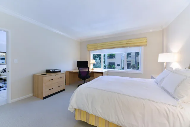 a bedroom with a bed and a table in it