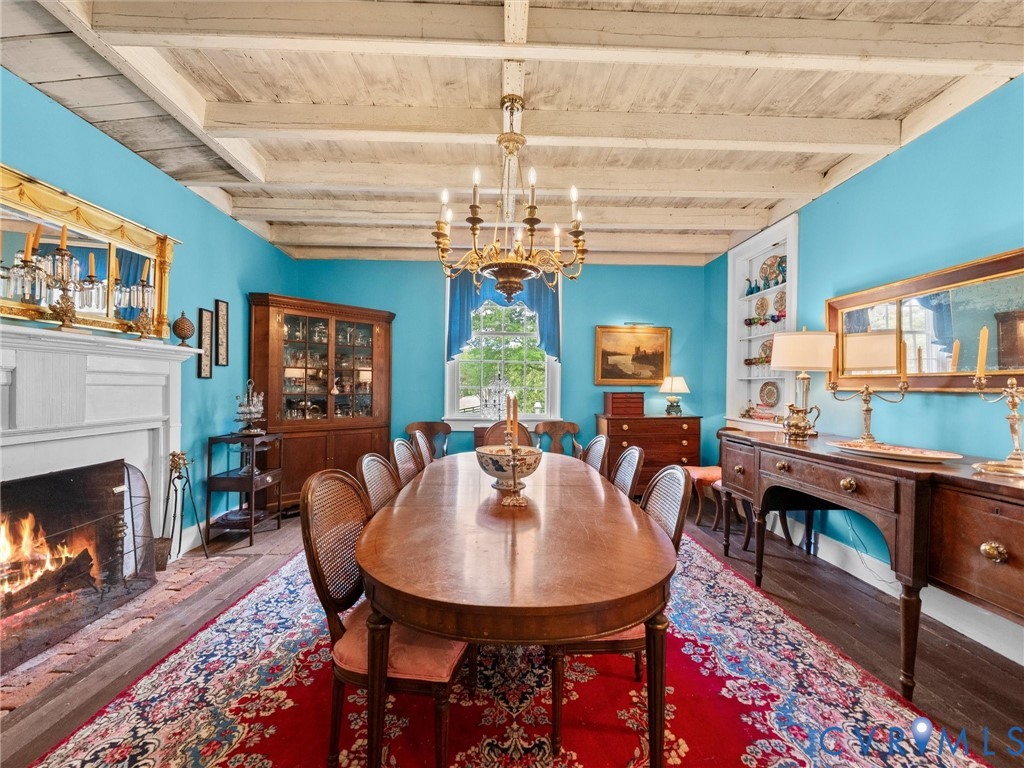 2625 Old Tavern Road Powhatan, VA 23139 - Photo 17 of 100 a view of a dining room with furniture a chandelier and wooden floor