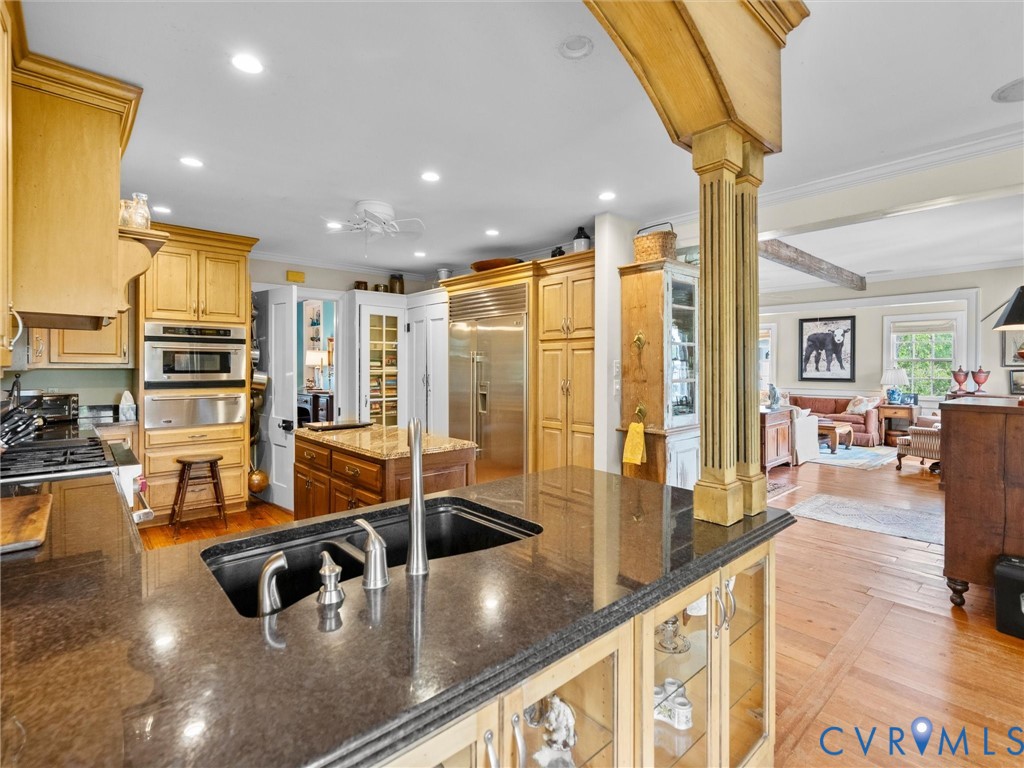 2625 Old Tavern Road Powhatan, VA 23139 - Photo 26 of 100 a kitchen with stainless steel appliances granite countertop a sink counter space and living room